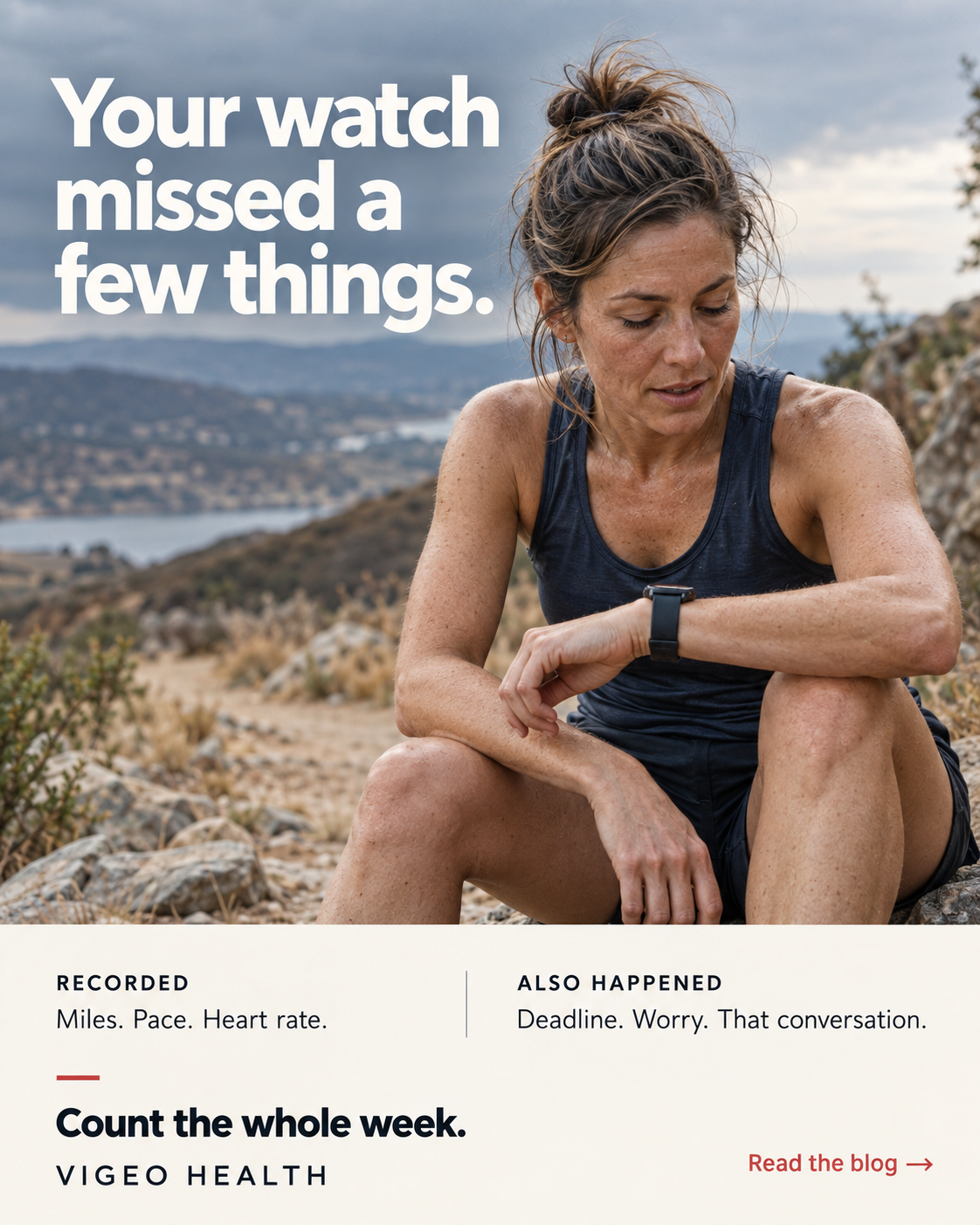 An athletic woman checking a sports watch outdoors.